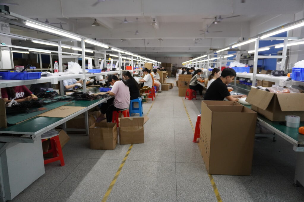 LED lighting production assembly line, workers assembling decorative string lights in factory workshop