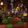 Outdoor Christmas laser projector light projects red green 10 Xmas patterns on street pavement, commercial shop street holiday decoration